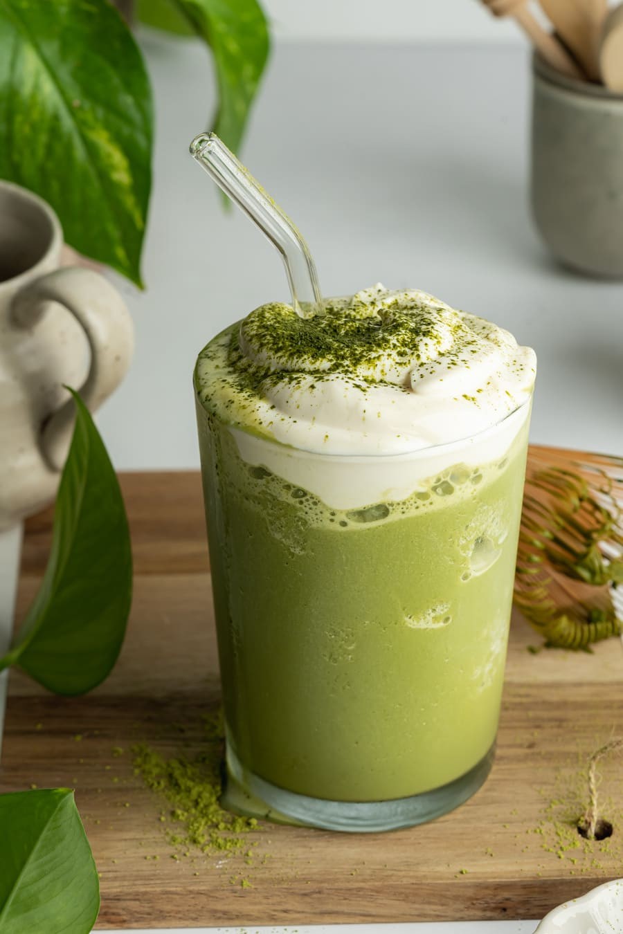 A vibrant green matcha latte with delicate latte art